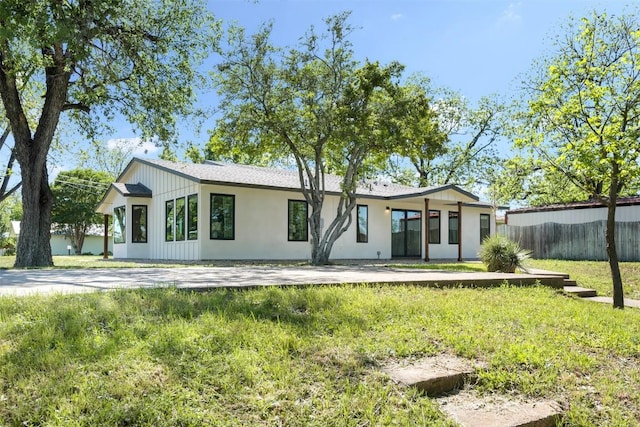 back of house with driveway and fence