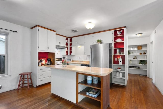 kitchen featuring open shelves, stove, freestanding refrigerator, and under cabinet range hood