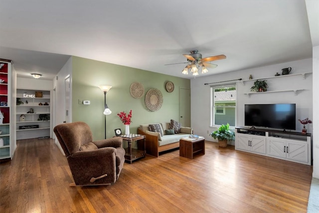 living room with a ceiling fan and wood finished floors