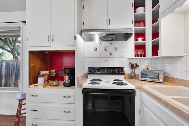 kitchen with a toaster, light countertops, decorative backsplash, ventilation hood, and range with electric cooktop