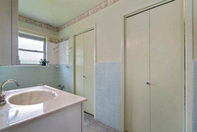 1805 Eubank St, Georgetown, TX 78626 - full bathroom with tile walls, vanity, a wainscoted wall, and a shower