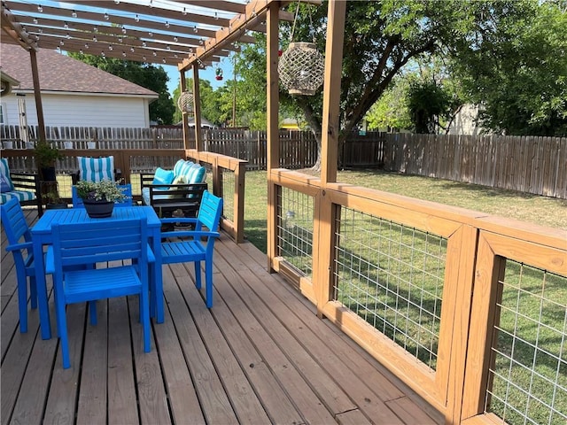 wooden deck featuring a lawn, a fenced backyard, and a pergola