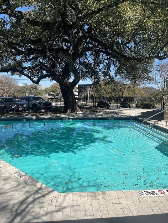 community pool featuring fence