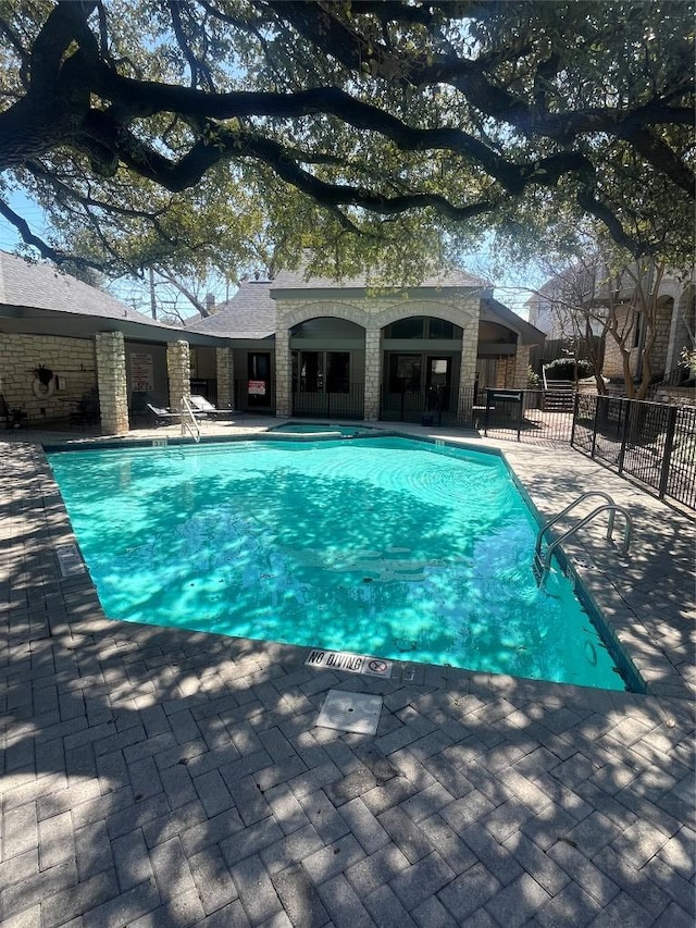 pool featuring fence and a patio