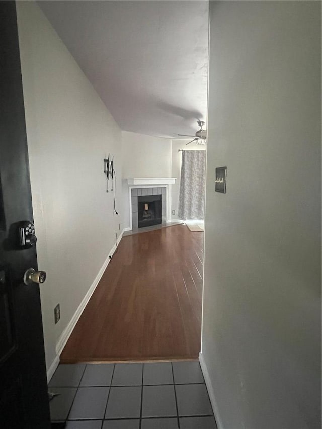 hall with tile patterned flooring and baseboards