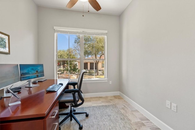 home office with ceiling fan and baseboards