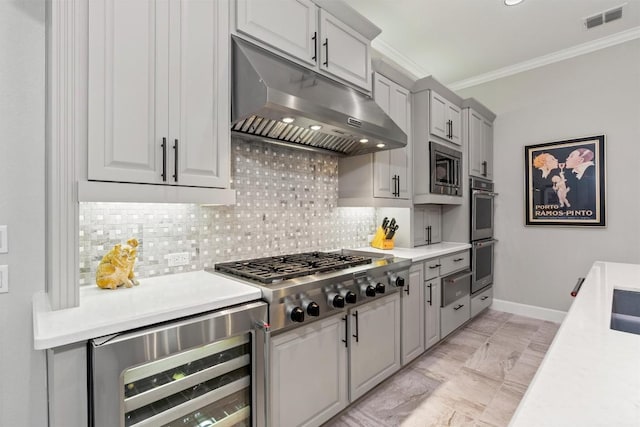 kitchen featuring under cabinet range hood, beverage cooler, stainless steel appliances, visible vents, and ornamental molding