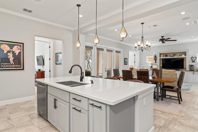 kitchen with a sink, visible vents, open floor plan, ornamental molding, and an island with sink