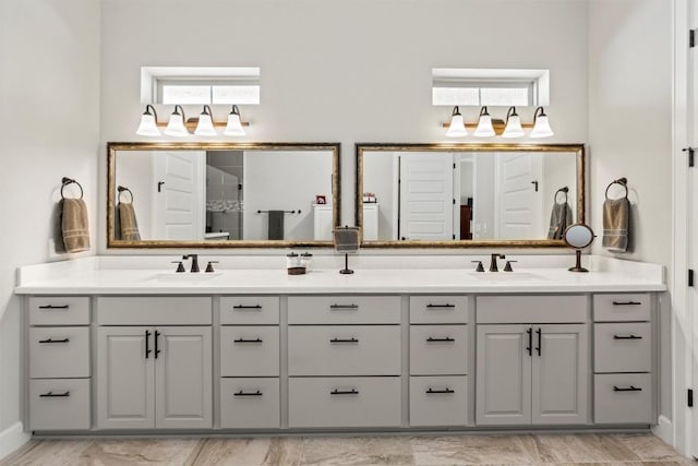 bathroom featuring walk in shower, a sink, and double vanity