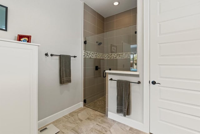 bathroom featuring recessed lighting, a shower stall, and baseboards