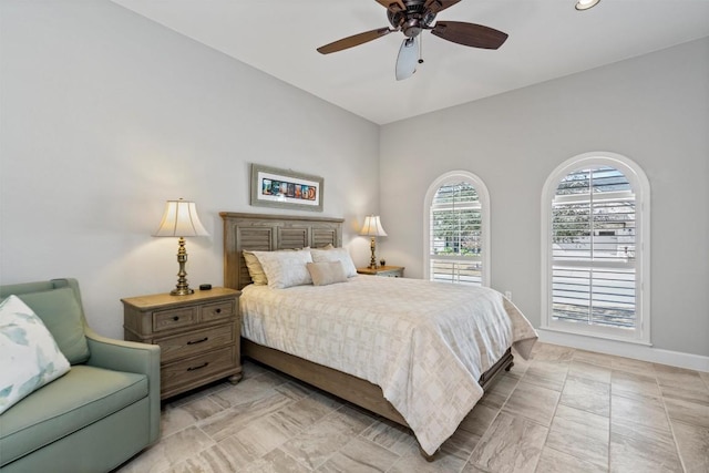 bedroom with baseboards and a ceiling fan