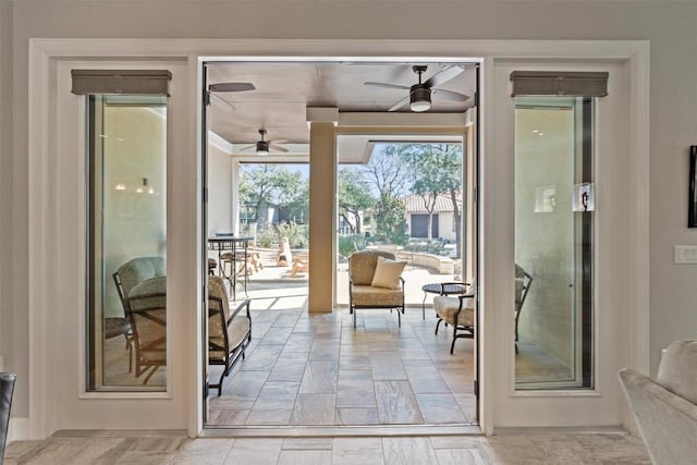 doorway to outside with a ceiling fan