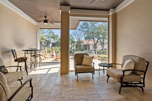 sunroom with a ceiling fan