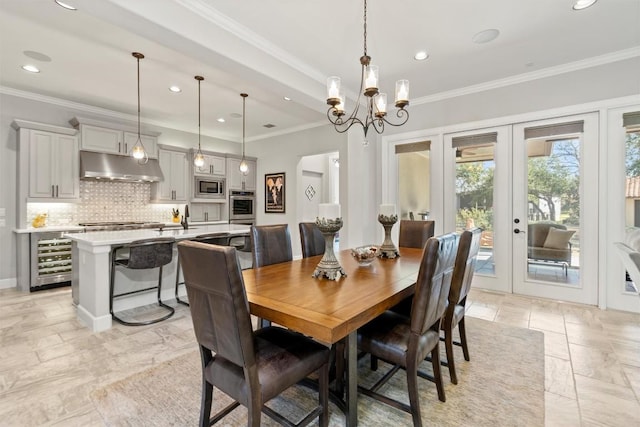 dining area with wine cooler, recessed lighting, french doors, stone tile flooring, and crown molding