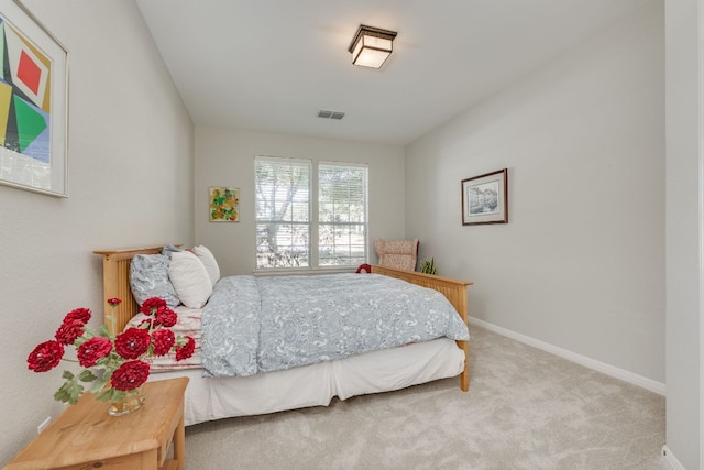 bedroom with baseboards, visible vents, and carpet flooring