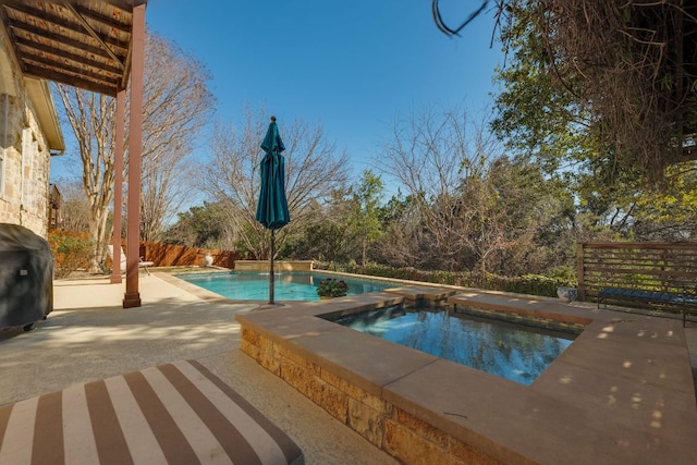 pool featuring area for grilling, an in ground hot tub, a patio area, and a fenced backyard