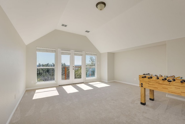 playroom with carpet floors, french doors, visible vents, vaulted ceiling, and baseboards