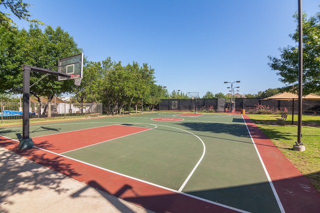 view of basketball court featuring community basketball court and fence