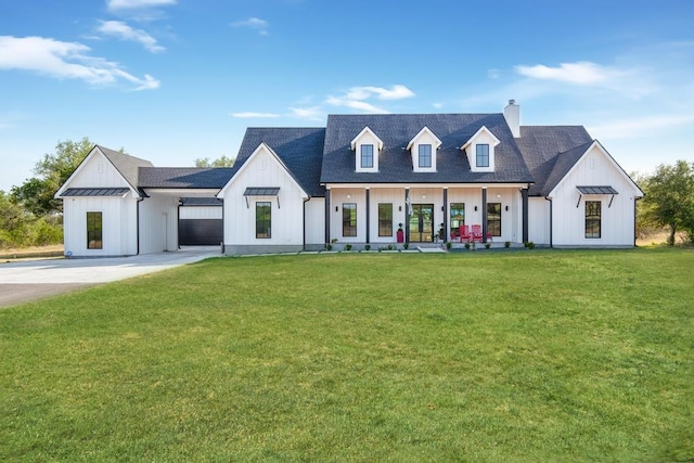 modern inspired farmhouse featuring a standing seam roof, metal roof, board and batten siding, and a front yard