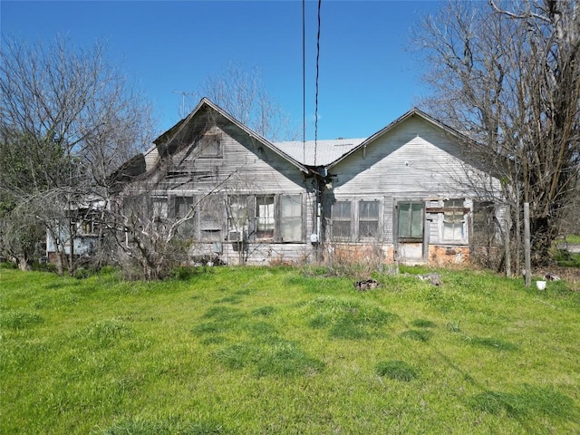 back of house with a lawn