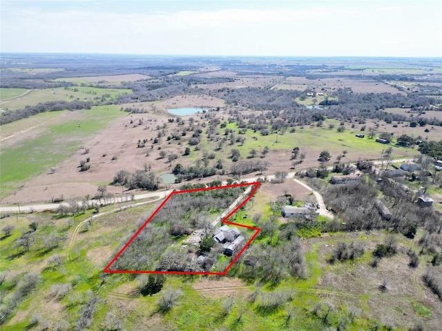 birds eye view of property featuring a rural view