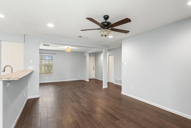 12314 Double Tree Ln, Austin, TX 78750 - unfurnished living room with a ceiling fan, dark wood finished floors, baseboards, recessed lighting, and a sink