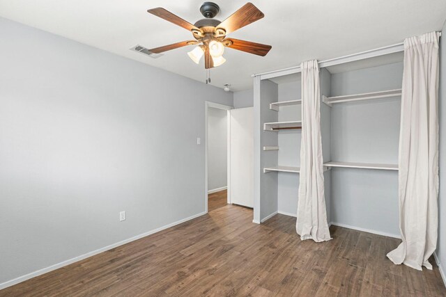 12314 Double Tree Ln, Austin, TX 78750 - unfurnished bedroom with wood finished floors, baseboards, and a ceiling fan
