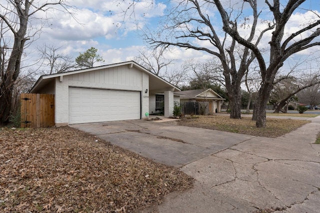 12314 Double Tree Ln, Austin, TX 78750 - view of front of house with concrete driveway, a garage, and brick siding