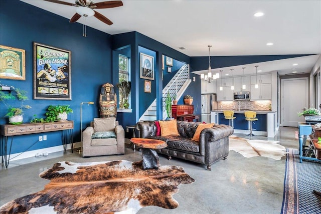 living area with lofted ceiling, stairs, recessed lighting, concrete flooring, and ceiling fan with notable chandelier
