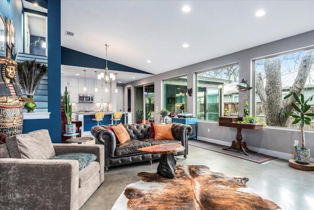 living room featuring lofted ceiling, plenty of natural light, a chandelier, and visible vents