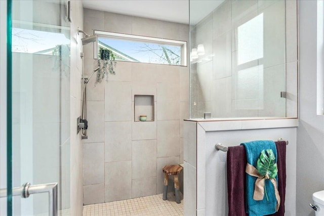 bathroom with a walk in shower and toilet