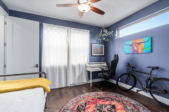 bedroom featuring a ceiling fan, baseboards, and wood finished floors