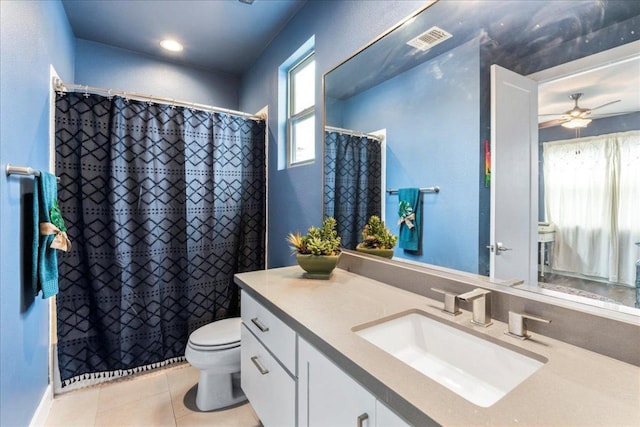 4404 Clarkson Ave, Austin, TX 78751 - bathroom with tile patterned floors, vanity, toilet, ceiling fan, and a shower with shower curtain