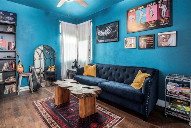 living room featuring ceiling fan, wood finished floors, and baseboards