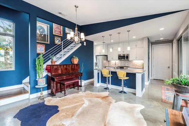 interior space featuring a chandelier, concrete floors, visible vents, baseboards, and stairs