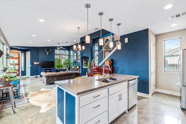 4404 Clarkson Ave, Austin, TX 78751 - kitchen featuring a sink, finished concrete floors, baseboards, appliances with stainless steel finishes, and an island with sink