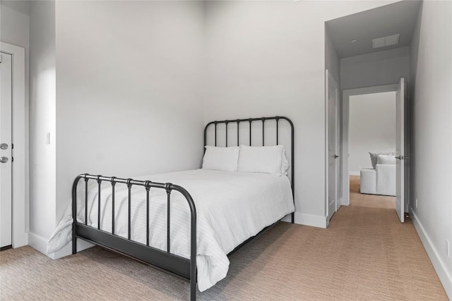 carpeted bedroom with visible vents and baseboards