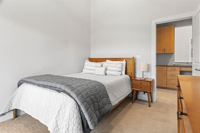 bedroom featuring light carpet