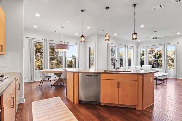 kitchen with a sink, visible vents, a healthy amount of sunlight, stainless steel dishwasher, and dark wood finished floors