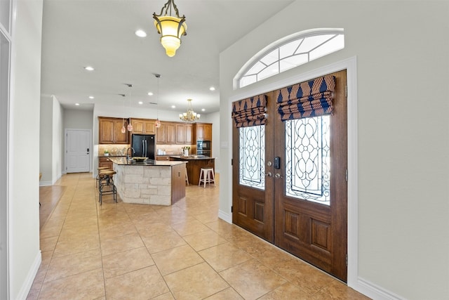 entrance foyer featuring recessed lighting, light tile patterned flooring, baseboards, and french doors