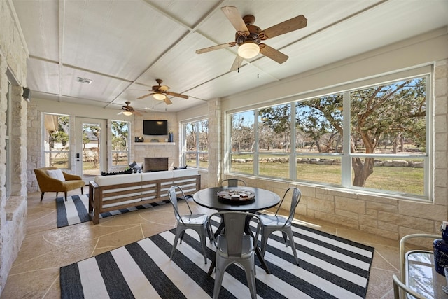 sunroom / solarium featuring visible vents and a fireplace