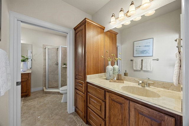 bathroom with toilet, tile patterned floors, a shower stall, and vanity