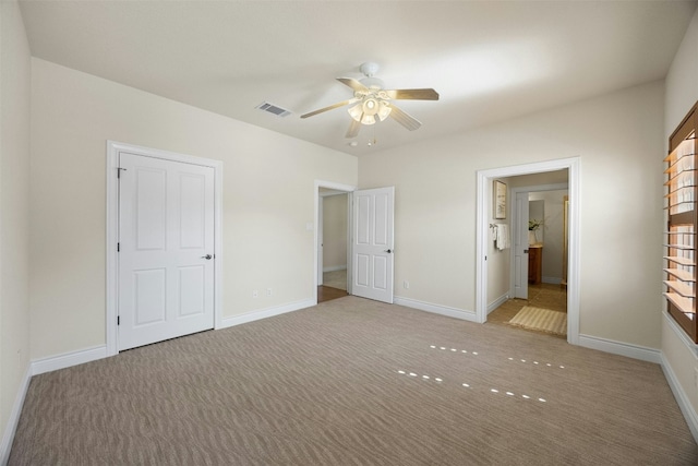 unfurnished bedroom with light carpet, baseboards, and visible vents