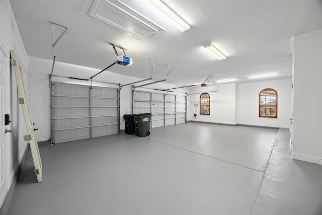 garage featuring baseboards and a garage door opener