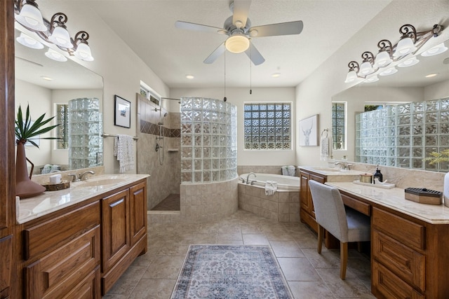 bathroom featuring walk in shower, two vanities, a sink, and a bath