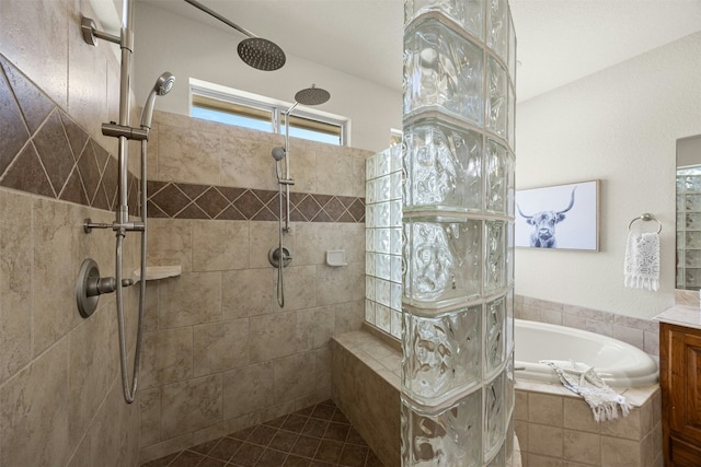 full bath with tile patterned floors, vanity, a bath, and a walk in shower