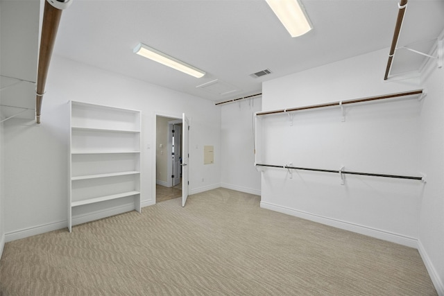 walk in closet with visible vents and carpet flooring