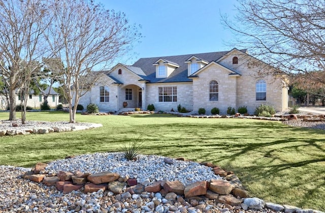 french country style house with a front yard