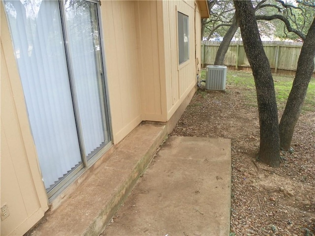 view of yard featuring fence and central air condition unit