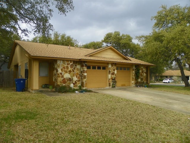 view of front facade featuring driveway, stone siding, an attached garage, and a front yard